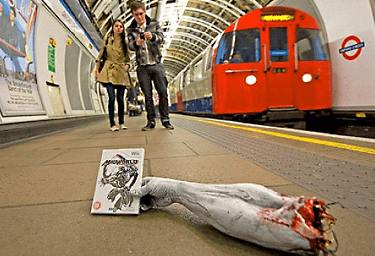 A severed arm holding a computer game on the Underground