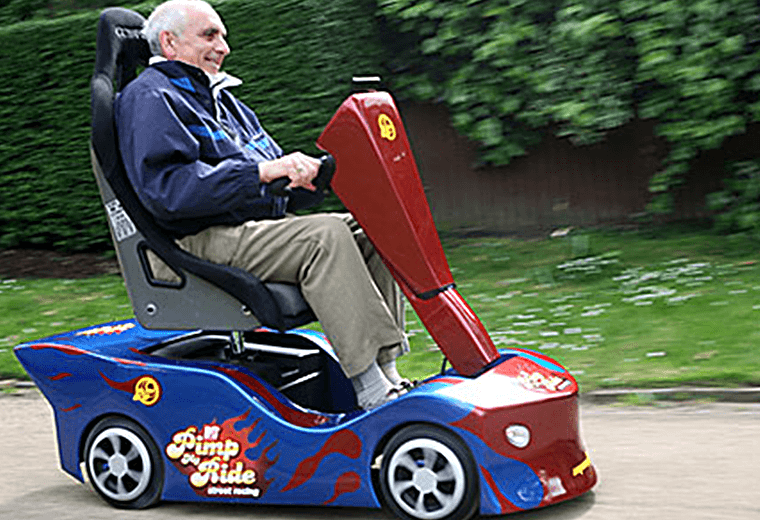 A man on a Pimp My Ride mobility scooter