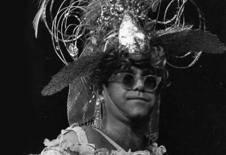 Elton John wearing a flamboyant headdress