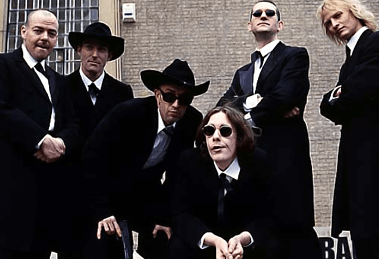 Alabama 3 posing in dark suits and sunglasses