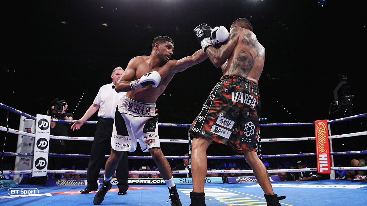 Boxer Amir Khan throws a punch against Samuel Vargas