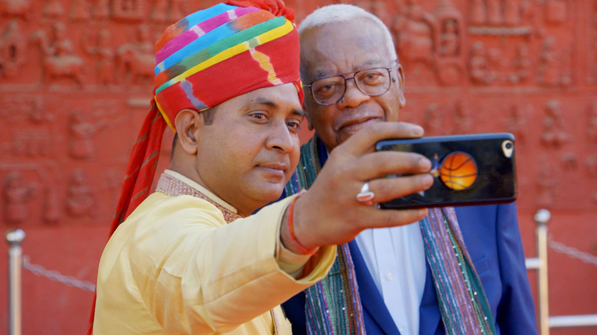 A man takes a selfie with broadcaster Trevor McDonald