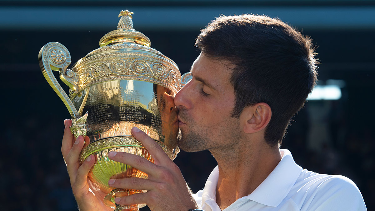 Novak Djokovic kisses the Wimbledon trophy