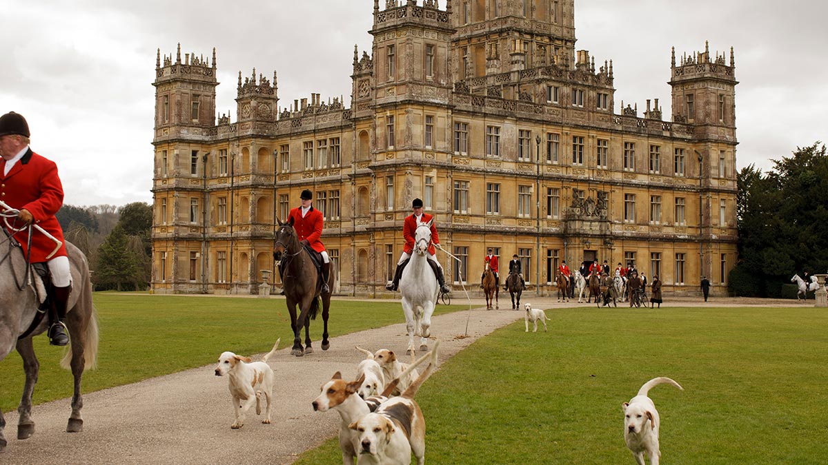 Highclere Castle with a hunting party in the foreground