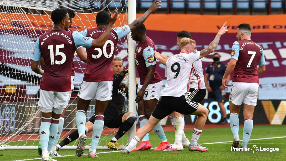Aston Villa goalkeeper Ørjan Nyland carrying the ball over his own line against Sheffield United in the Premier League