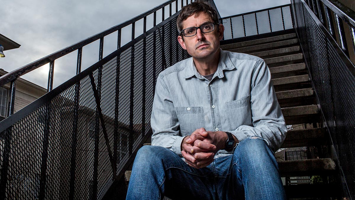 Louis Theroux sat on some stairs