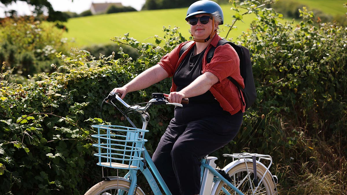 SIobhan McSweeney on a bicycle in Exploring Northern Ireland